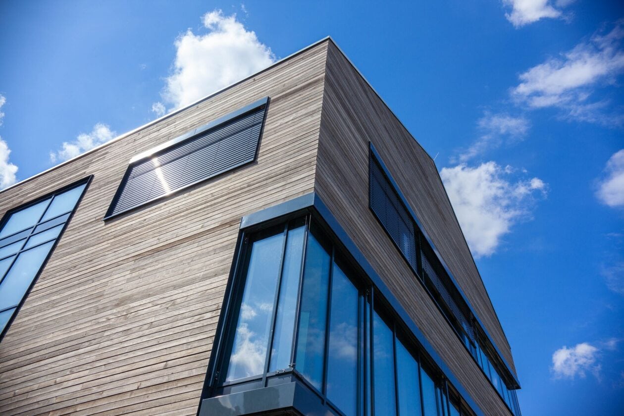 Modern exterior view of the Sport-Thieme company building with sustainable wooden facade and large windows.