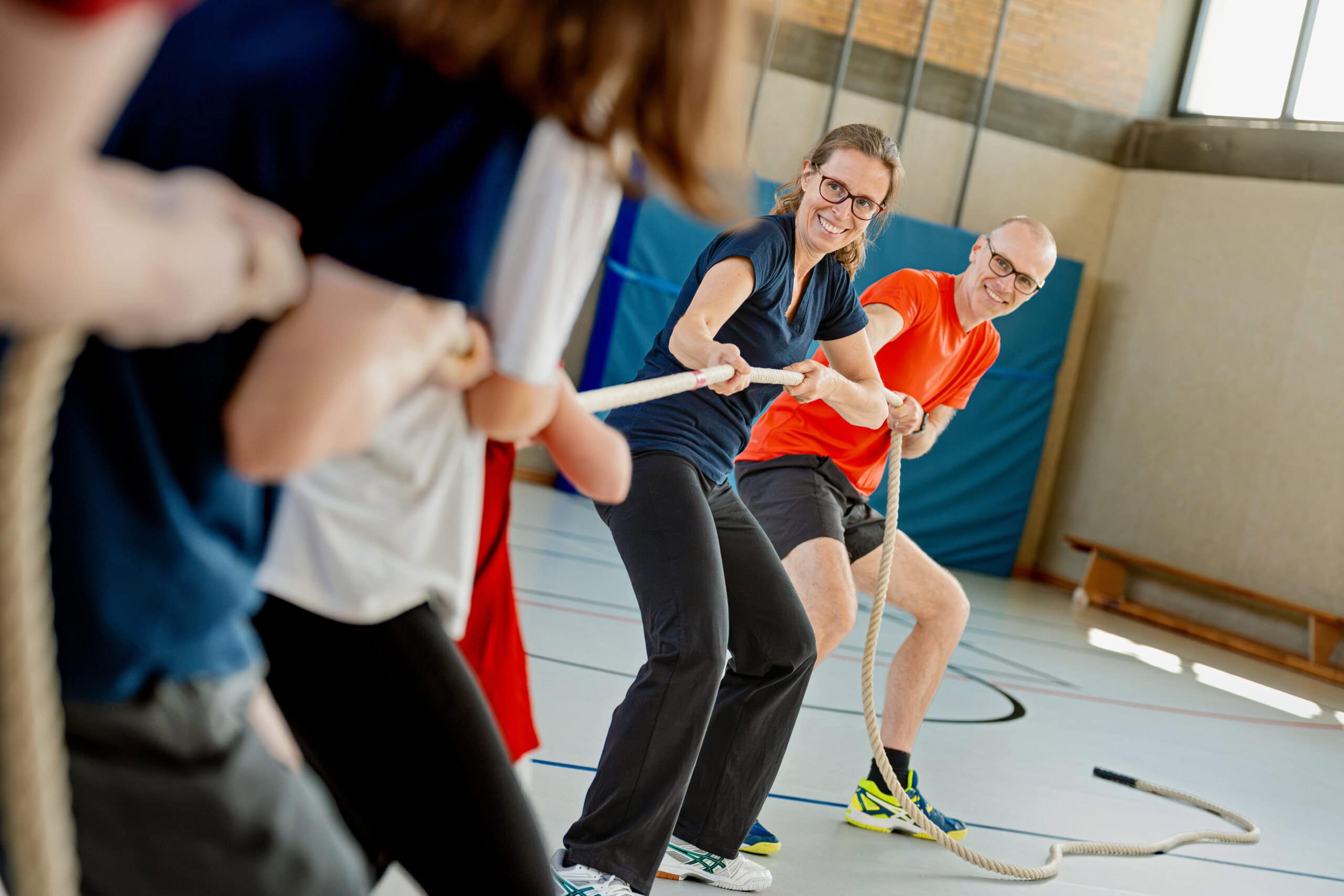 Maximilian Hohe and Katharina Thieme-Hohe playing tug-of-war in a sports hall against the Sport-Thieme family.