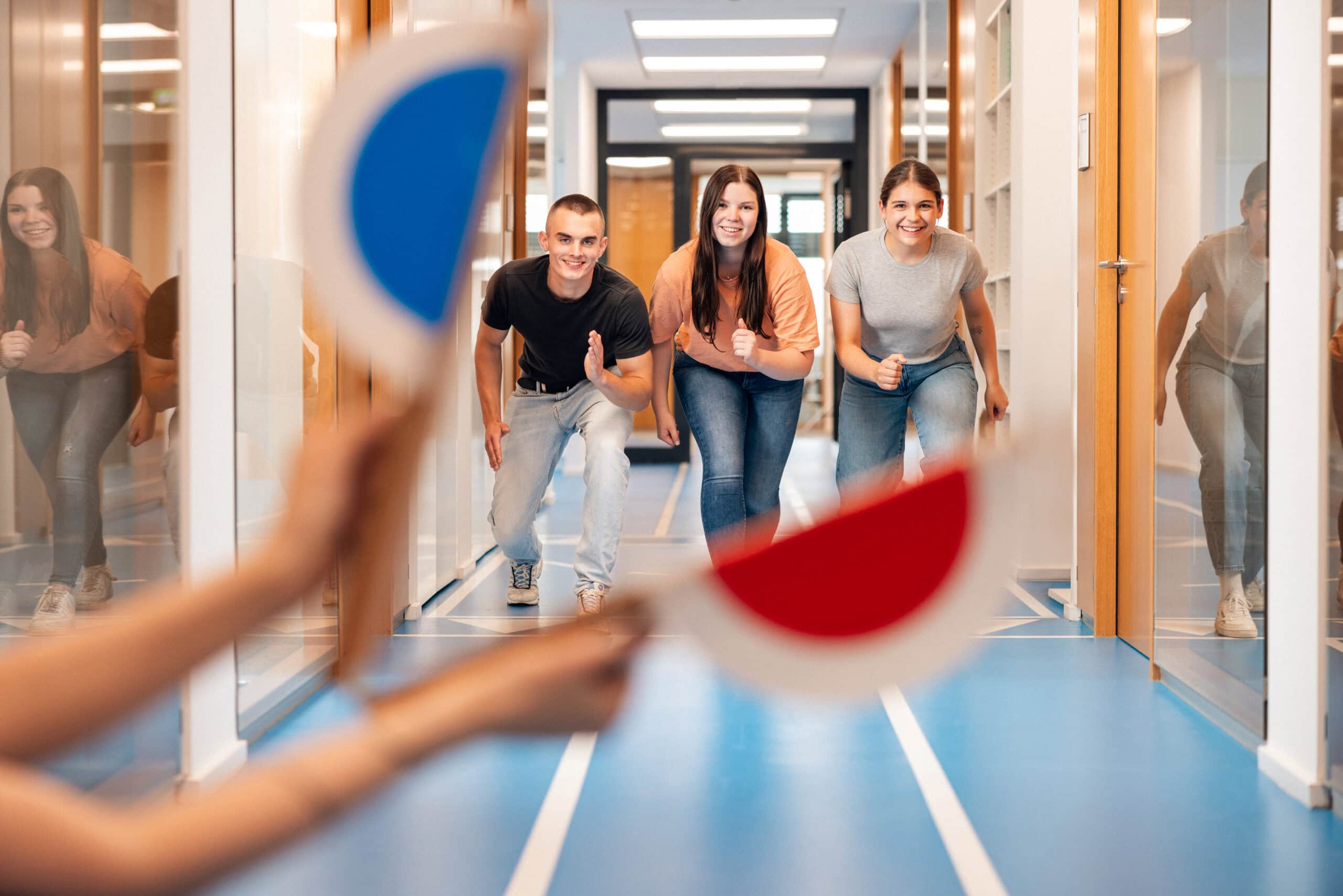 Trainees start a sprint duel in the office hallway.